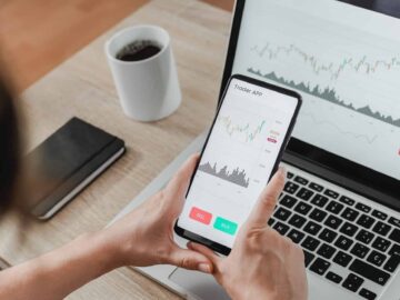 Forex trader using crypto exchange mobile phone app for investment and stock market analysis at hedge fund office - Focus on screen